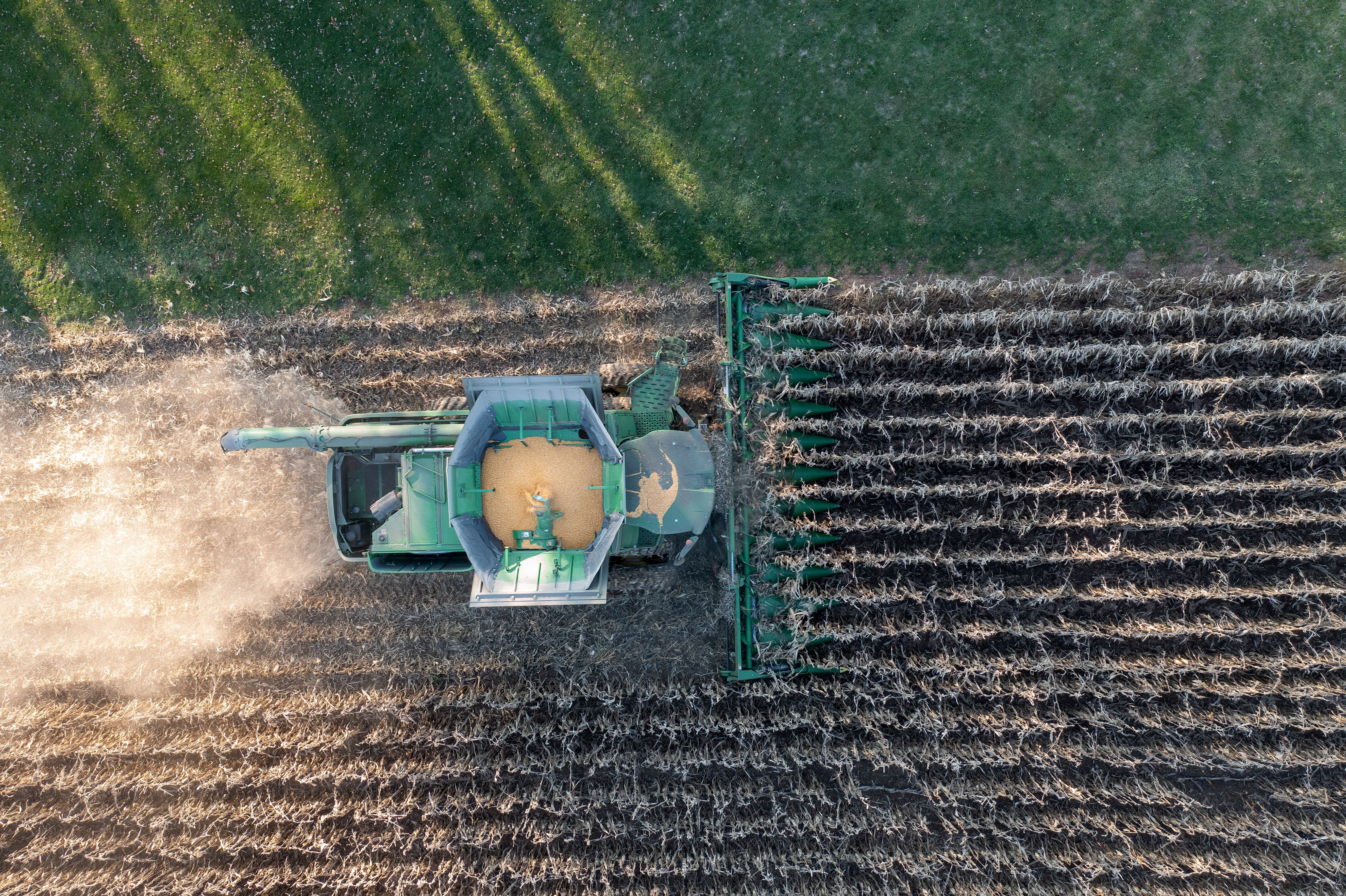 Overhead view of a combine unloading corn into a grain cart