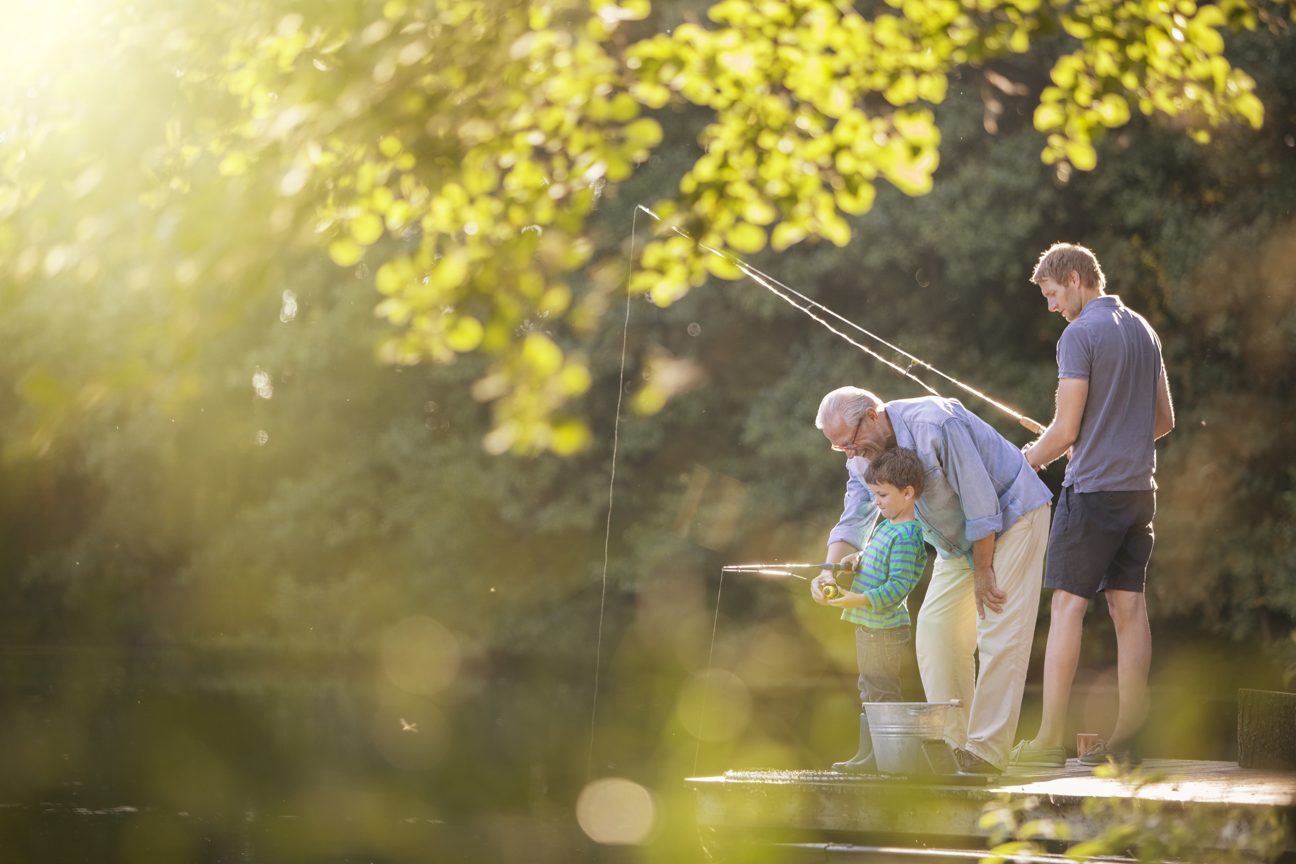 Three generations fishing at a lake